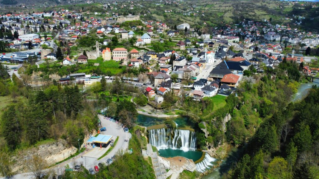 Stunning aerial Pliva waterfall connects perfectly when you visit Jajce and Travnikshot of Jajce's historic townscape and waterfall in Bosnia and Herzegovina.