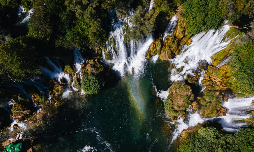 Stunning aerial shot of Kravice Waterfalls surrounded by lush greenery in Bosnia and Herzegovina.