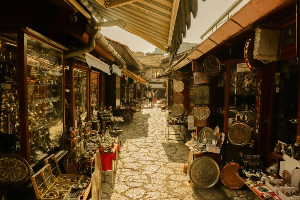 pexels-photo-12575747-12575747 Explore a quaint alleyway filled with antique shops and market stalls shining under the sun.